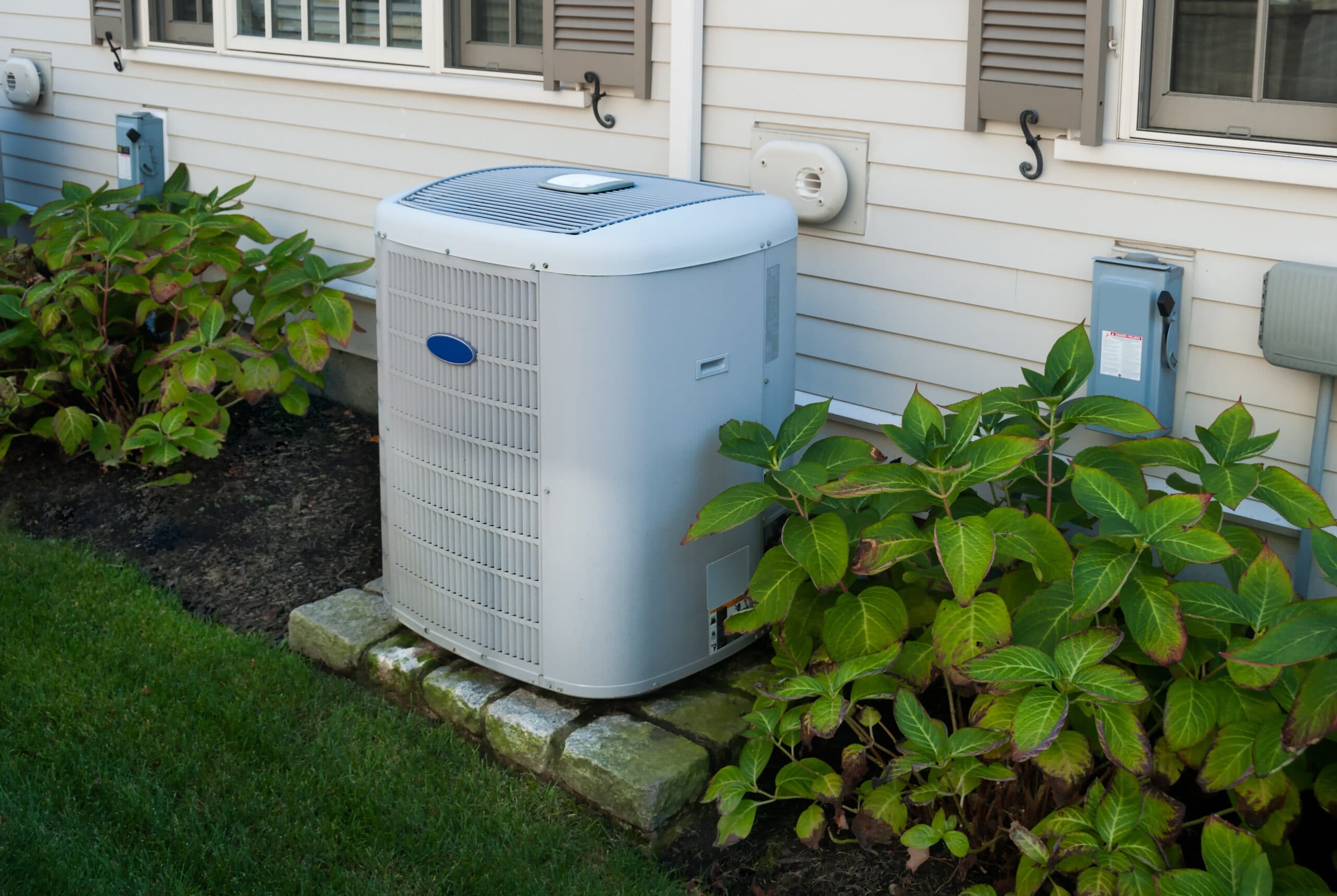 HVAC technician servicing air conditioning unit